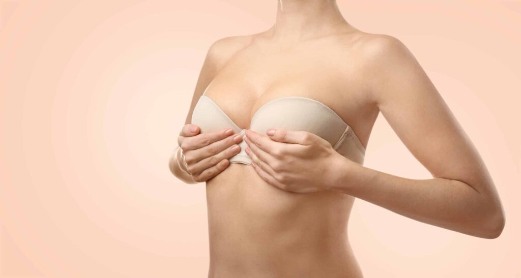 Close up of woman holding her breasts wanting breast lift in Huntington Beach, CA