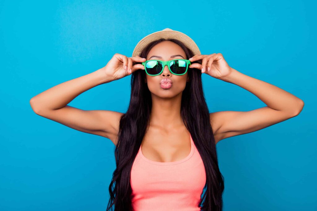 Woman making kissing face with larger breasts from breast augmentation in Huntington Beach